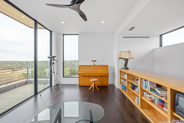 sitting room featuring dark hardwood / wood-style flooring and ceiling fan