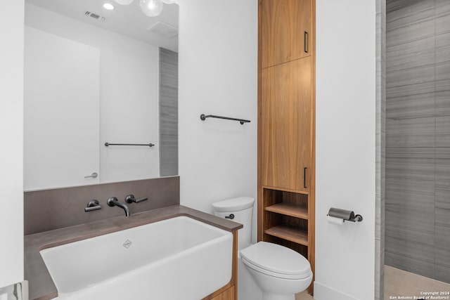 bathroom featuring toilet and vanity