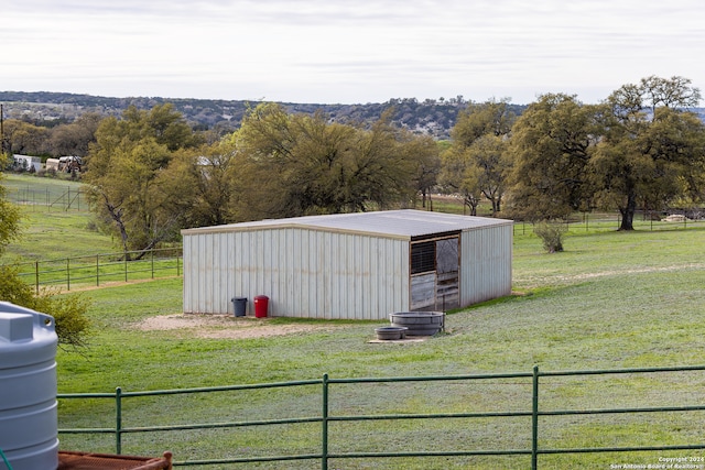 view of outbuilding with a yard and a rural view