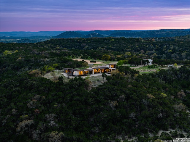 aerial view at dusk featuring a mountain view