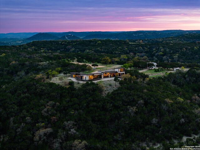 aerial view at dusk featuring a mountain view