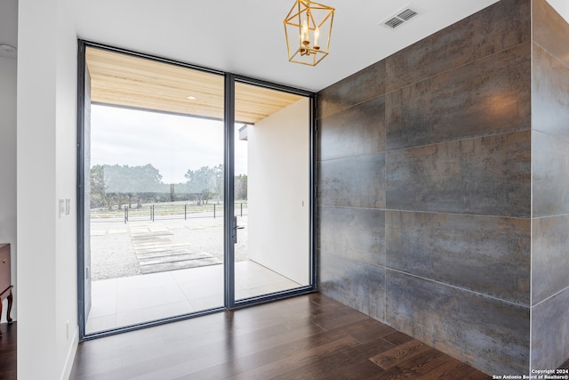 entryway featuring a chandelier and dark hardwood / wood-style floors