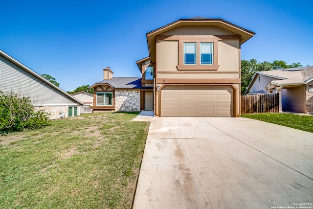 view of property featuring a garage and a front lawn