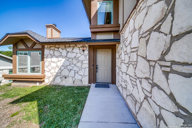 doorway to property with a yard