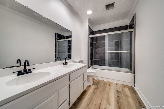 full bathroom with ornamental molding, enclosed tub / shower combo, wood-type flooring, and double sink vanity