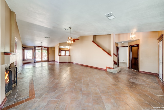 unfurnished living room featuring ceiling fan and light tile floors