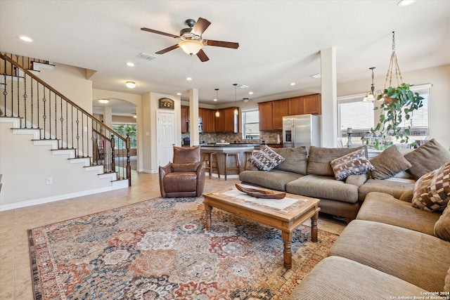 living room featuring ceiling fan and light tile flooring