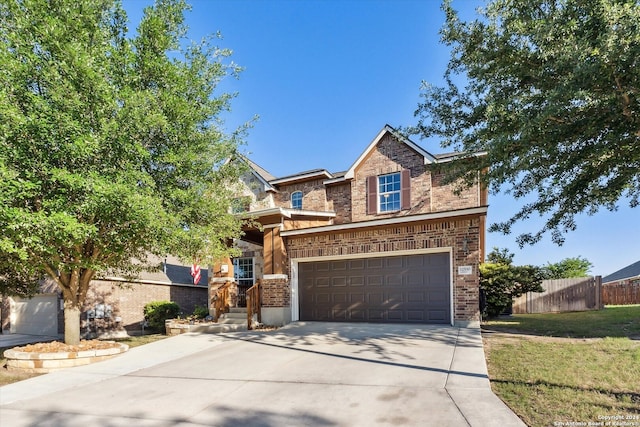 view of front of home with a garage and a front lawn