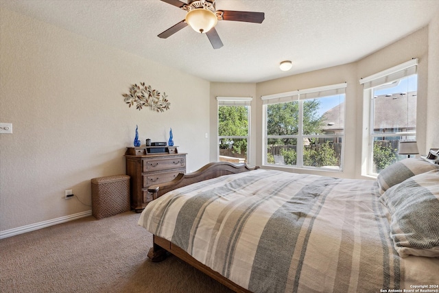 bedroom featuring ceiling fan, carpet flooring, and a textured ceiling