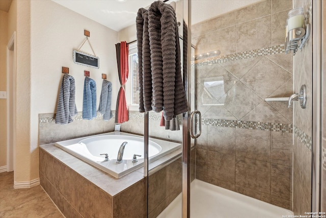 bathroom with tile floors and independent shower and bath