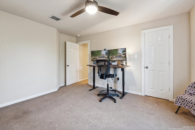 carpeted office space with ceiling fan