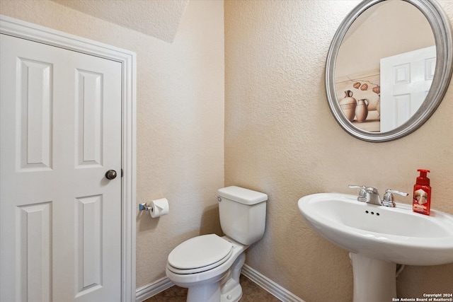 bathroom featuring toilet and tile flooring