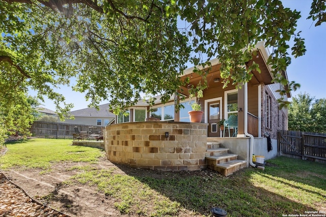 rear view of house featuring a lawn