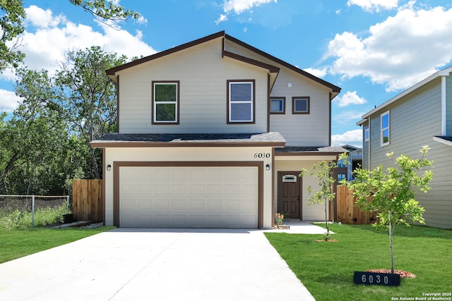 view of front facade featuring a garage and a front yard