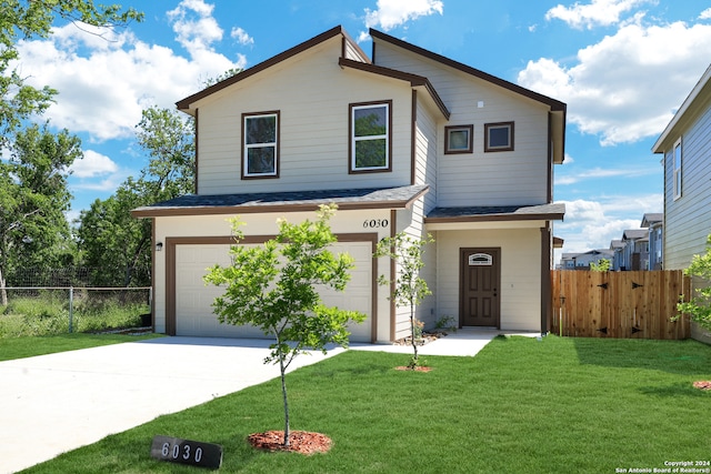 view of front of house featuring a garage and a front yard