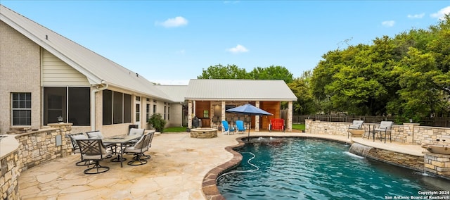 view of swimming pool featuring pool water feature and a patio area