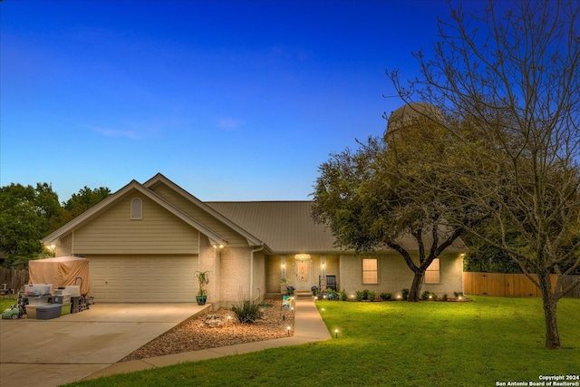 single story home with a front yard and a garage