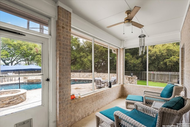 sunroom / solarium featuring ceiling fan