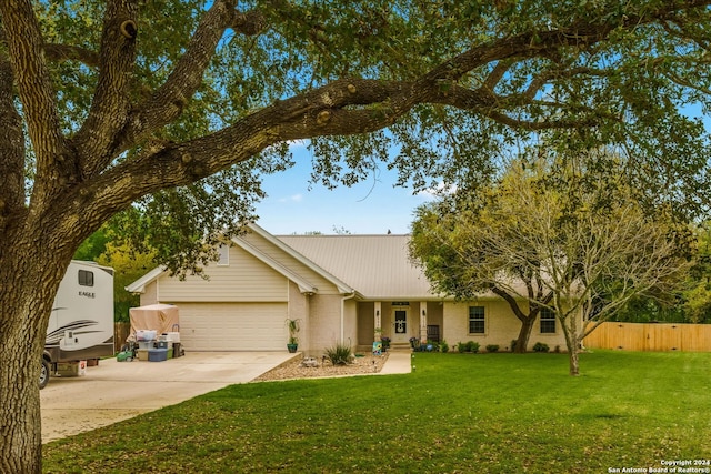 ranch-style home with a front yard and a garage