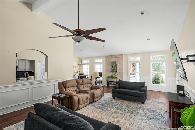 living room featuring beamed ceiling, ceiling fan, high vaulted ceiling, brick wall, and wood-type flooring