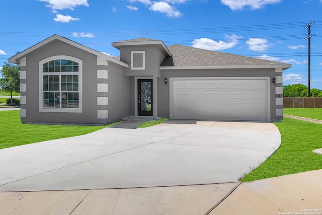 view of front of house with a front yard and a garage