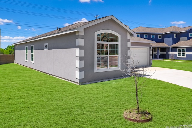 view of front of property featuring a garage and a front lawn