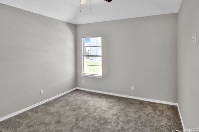 unfurnished room with dark carpet and ceiling fan