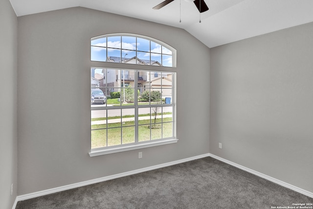 carpeted empty room featuring ceiling fan and lofted ceiling