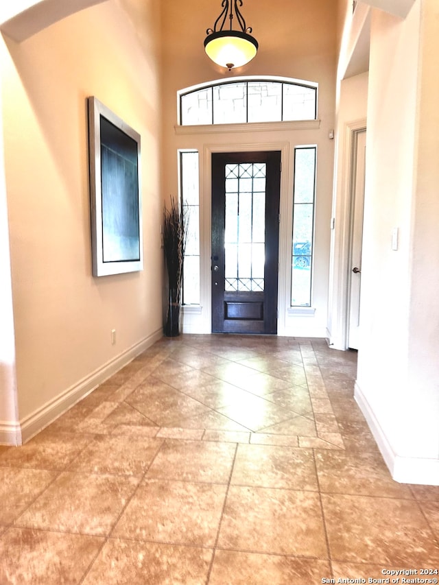 entrance foyer with a high ceiling and tile patterned floors