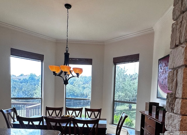 dining area with a chandelier and crown molding