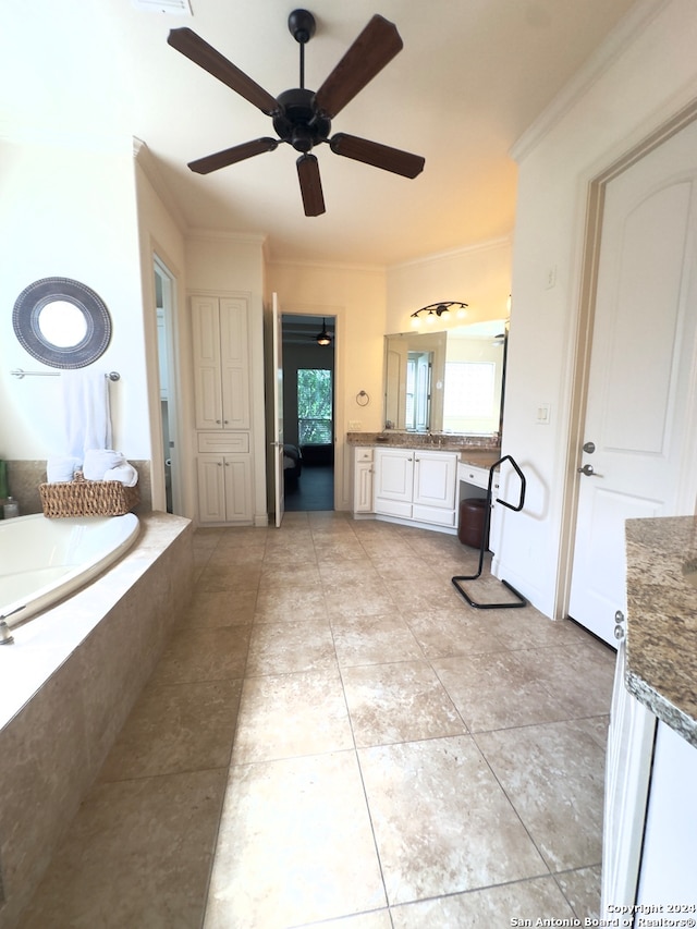 interior space featuring vanity, tiled bath, tile patterned flooring, ornamental molding, and ceiling fan