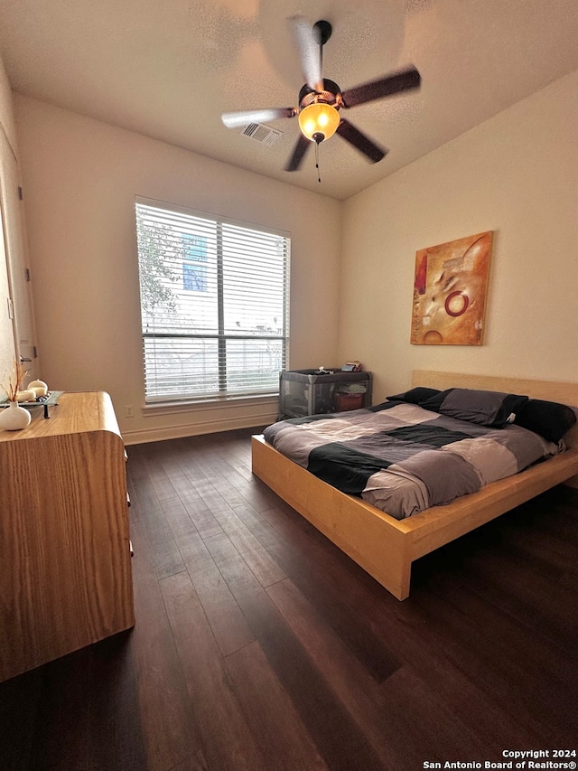 bedroom featuring ceiling fan and dark hardwood / wood-style floors