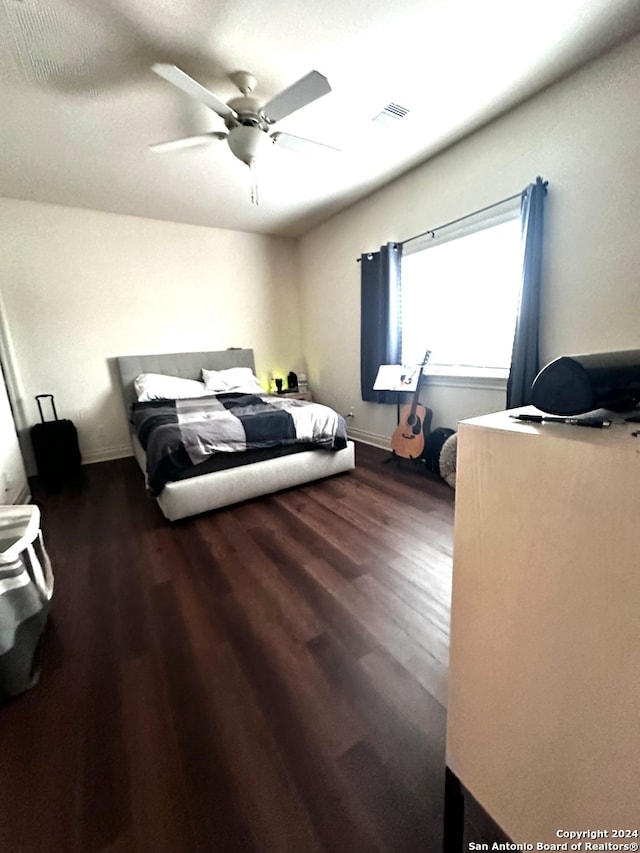 bedroom with ceiling fan and dark hardwood / wood-style flooring