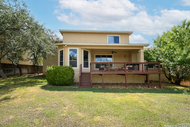 back of house featuring a yard, ceiling fan, and a deck