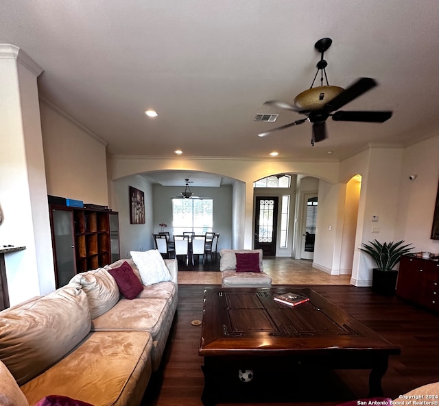 living room featuring crown molding, hardwood / wood-style floors, and ceiling fan