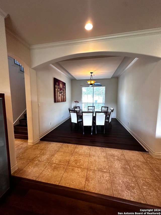 unfurnished dining area with ceiling fan, hardwood / wood-style flooring, and ornamental molding