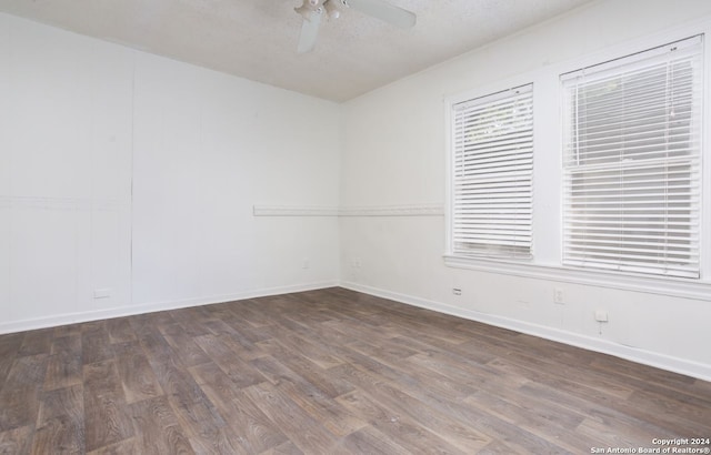 spare room with ceiling fan and dark hardwood / wood-style floors