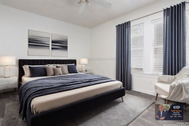 bedroom with ceiling fan and dark hardwood / wood-style floors