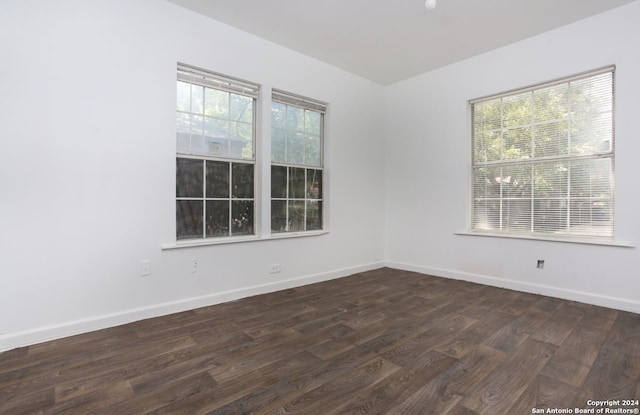 unfurnished room featuring dark wood-type flooring