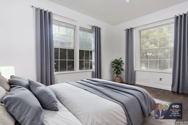 bedroom with dark hardwood / wood-style floors