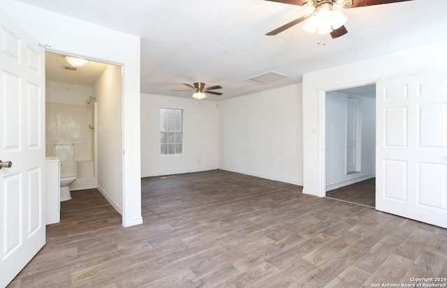 empty room with dark hardwood / wood-style flooring and ceiling fan