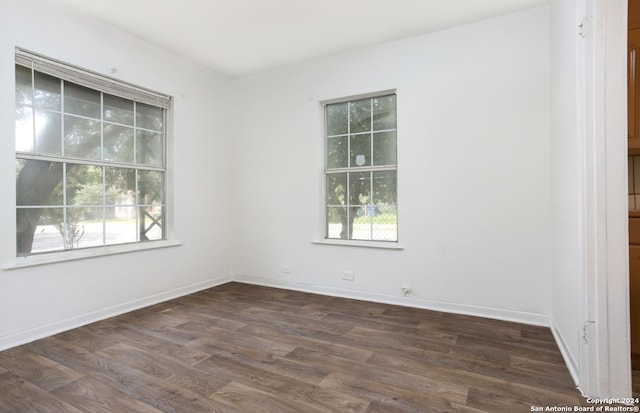 spare room with dark hardwood / wood-style floors