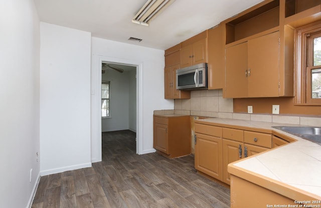 kitchen with tile counters, tasteful backsplash, and dark wood-type flooring