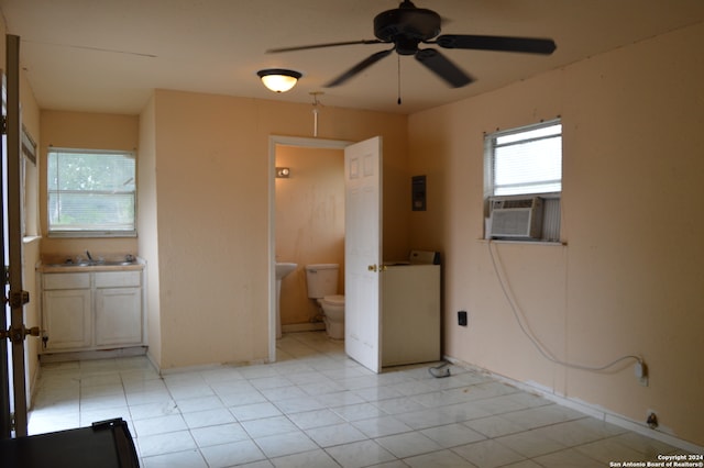 interior space with ceiling fan, a wealth of natural light, and washer / dryer