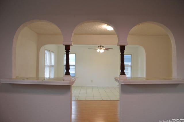 kitchen with ceiling fan, light tile floors, and a textured ceiling