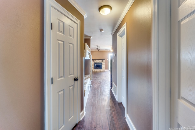 corridor with dark hardwood / wood-style flooring and crown molding