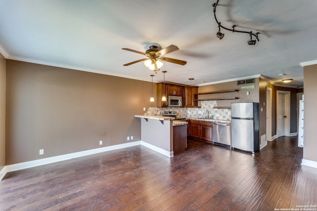 kitchen with kitchen peninsula, dark wood-type flooring, stainless steel appliances, and light stone countertops