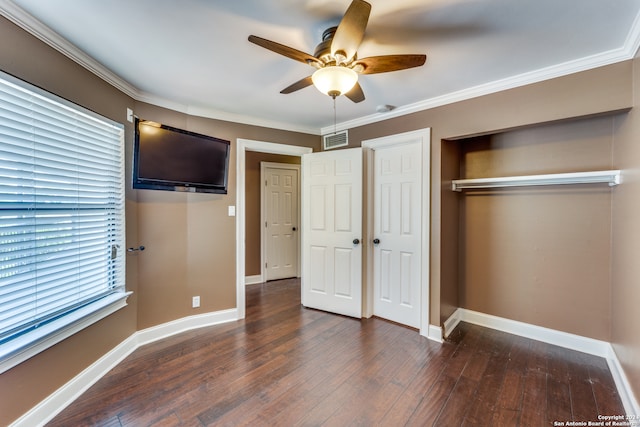 unfurnished bedroom featuring dark hardwood / wood-style floors, ceiling fan, and ornamental molding