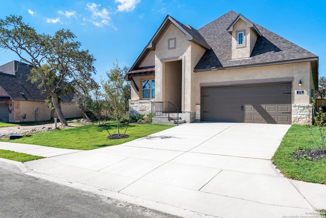 french country home featuring a garage and a front yard