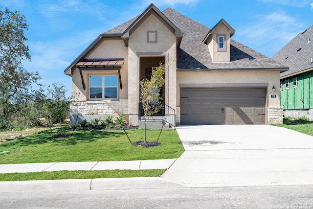 view of front of house featuring a garage and a front lawn